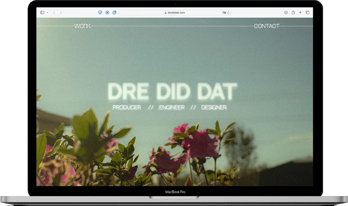 website with a sky blue background and a rose bush with a large title that says "Dre Did Dat - producer, engineer, designer" - mocked up on a MacBook Pro