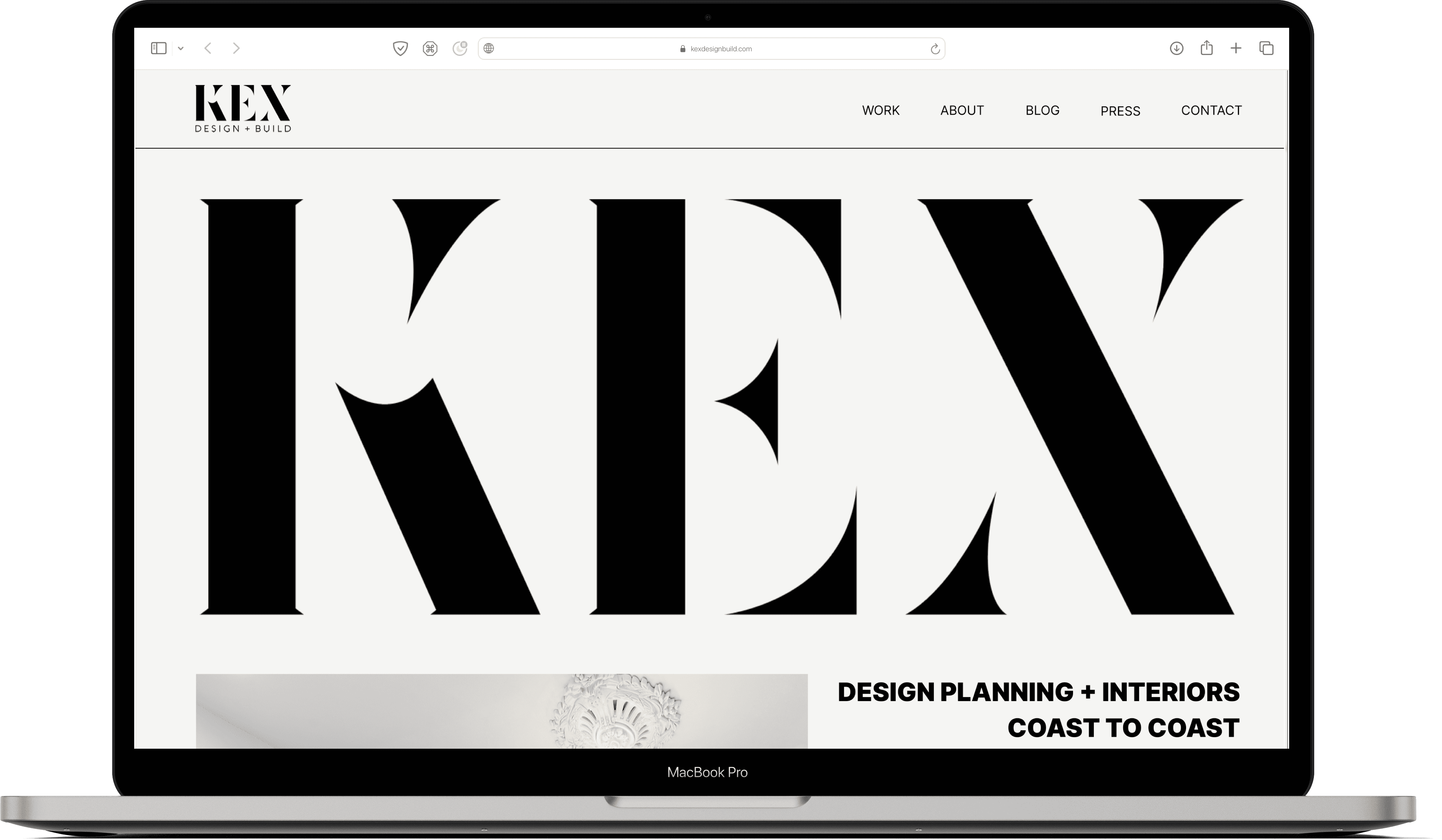 website homepage with a large KEX logo mocked up on a MacBook Pro