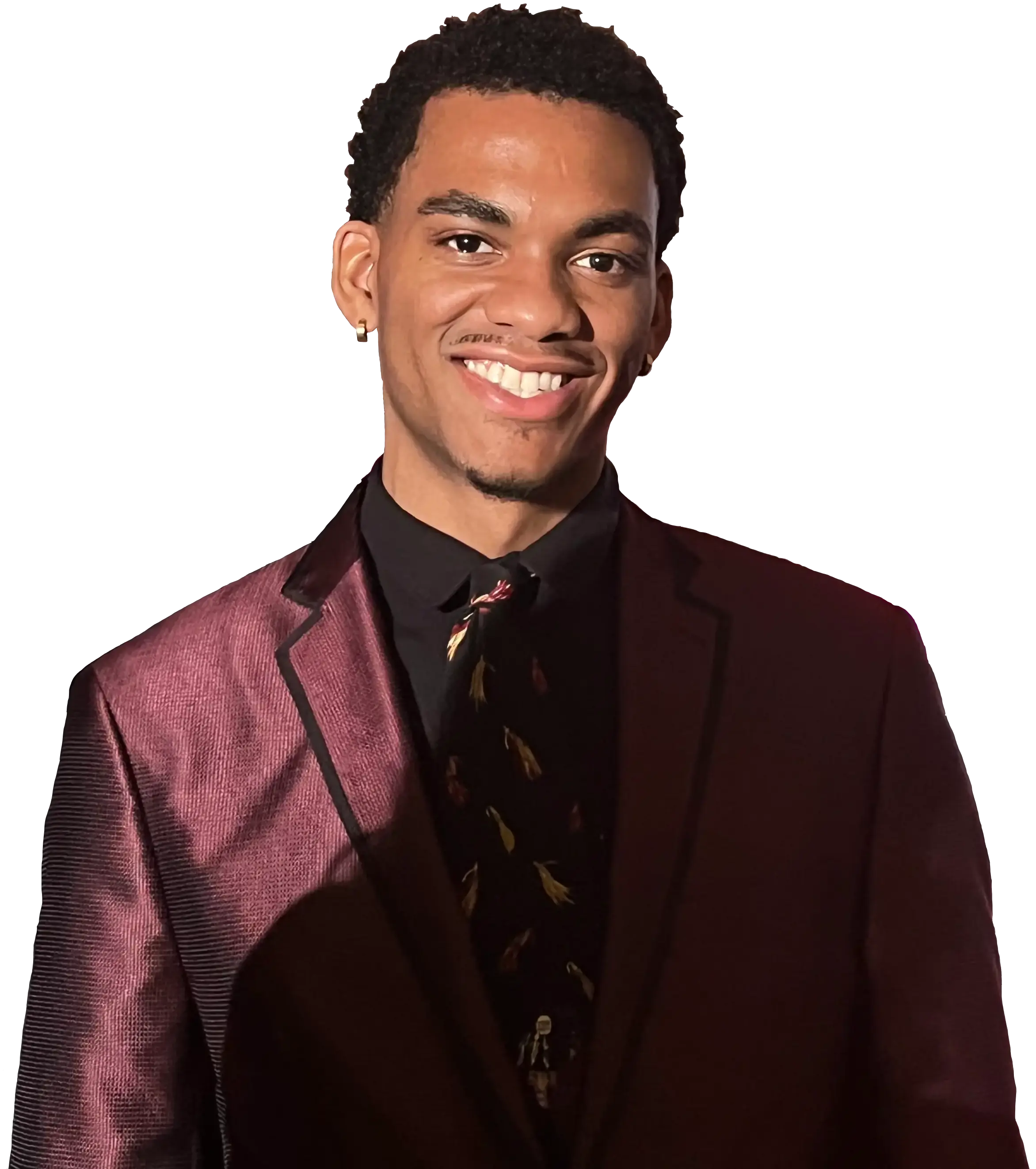 a handsome, young black man with a small afro smiling in a burgundy suit and black dress shirt