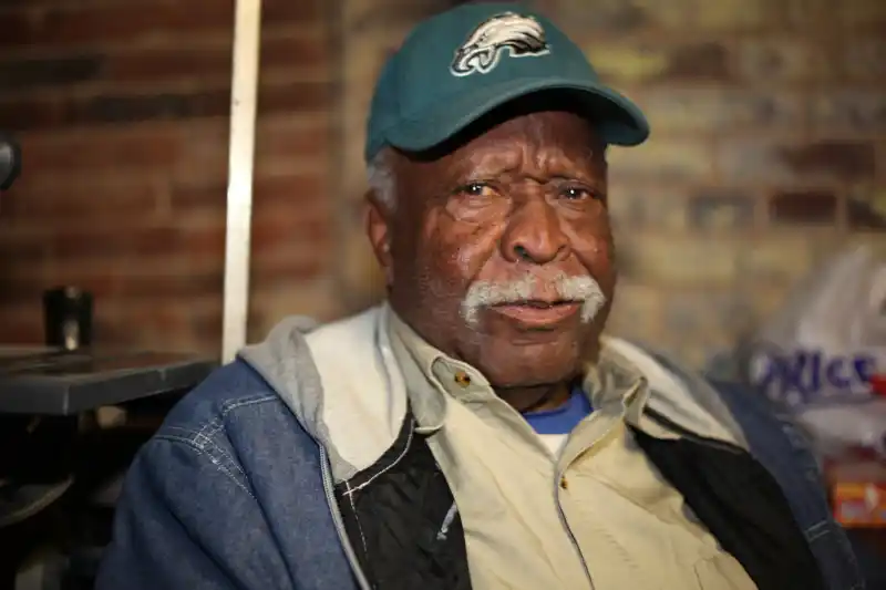 older black man with a grey mustache and a Philadelphia eagles hat